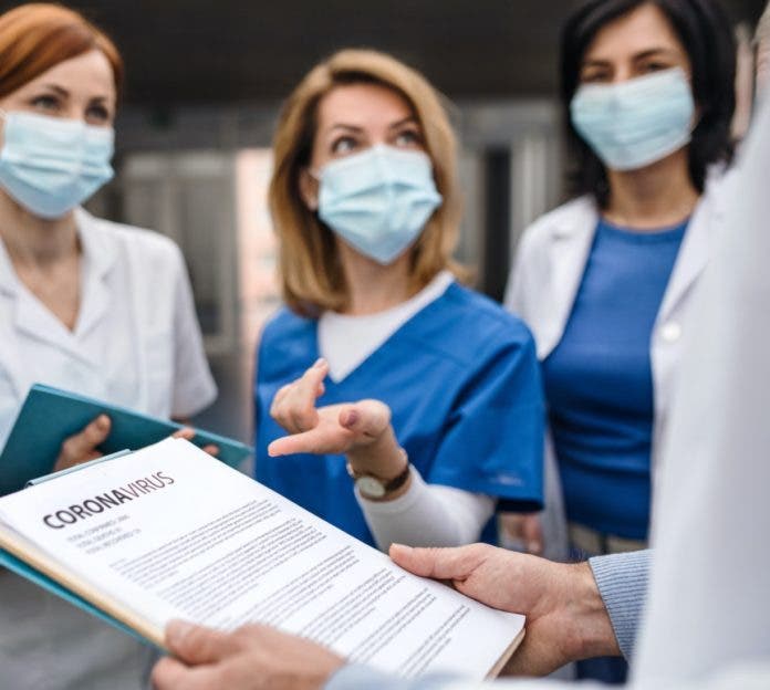 Group of doctors talking about corona virus on conference.