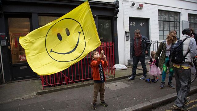 Niño ondeando bandera con la carita feliz